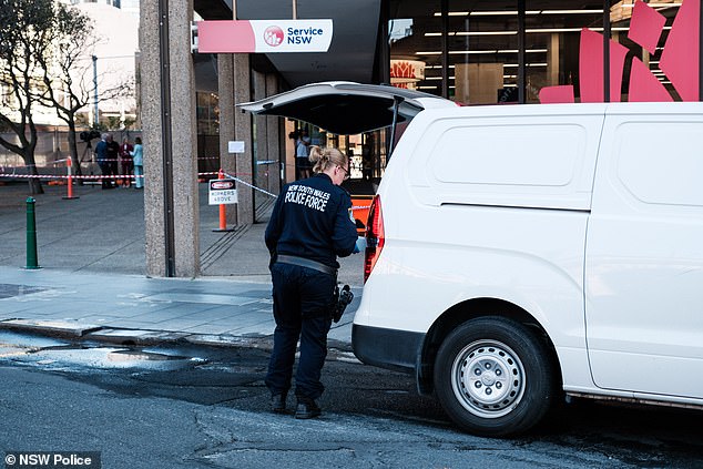 Police have taken a man 55, into the custody over the alleged stabbing (pictured, police at the scene)