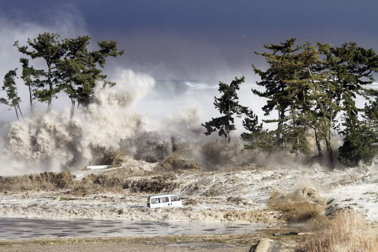 A white van is seen being swallowed up by tsunami waves in Japan
