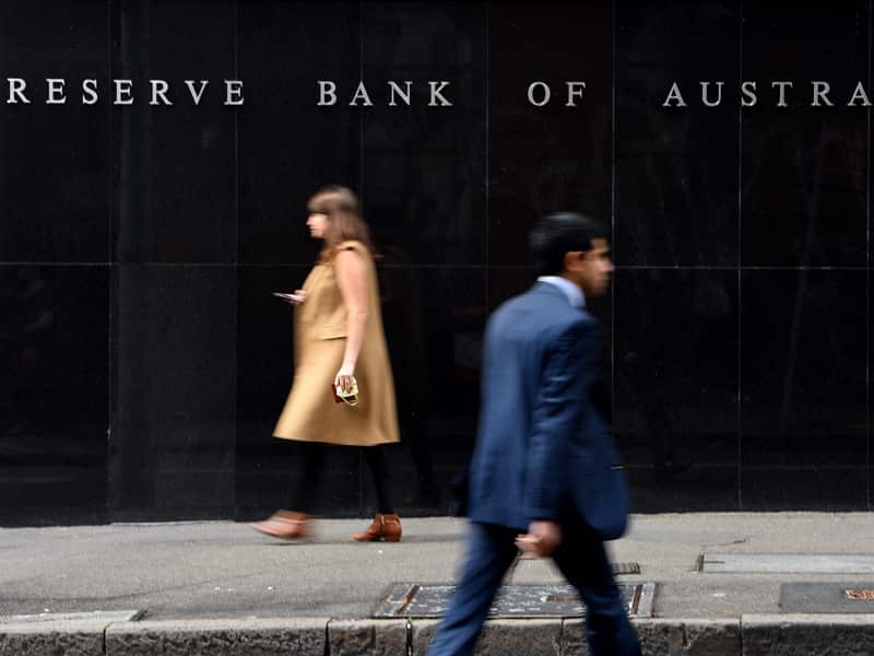 Pedestrians walking past the Reserve Bank of Australia building in Sydney.