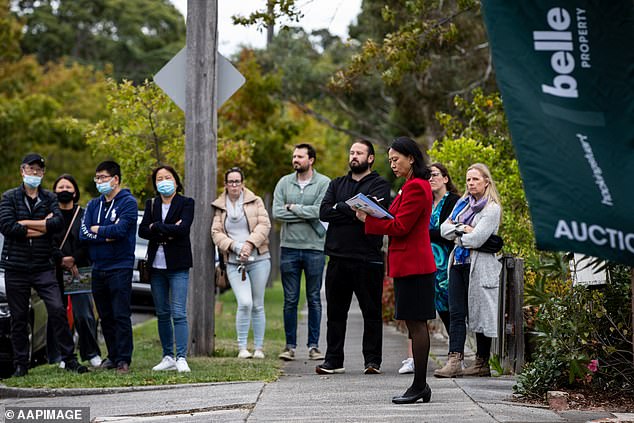 The average new Australian mortgage has surged to a record-high of $624,383 even though the Reserve Bank has raised interest rates 13 times in 18 months (pictured is an auction in Melbourne)