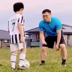 Kwang Kyung Yoo playing soccer with a child in 2022.