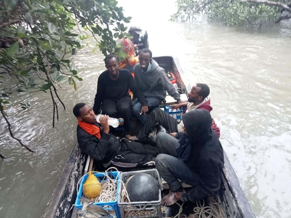 five men in a dinghy