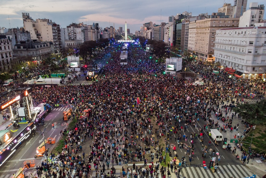 A large outdoor parade with lots of people taking part