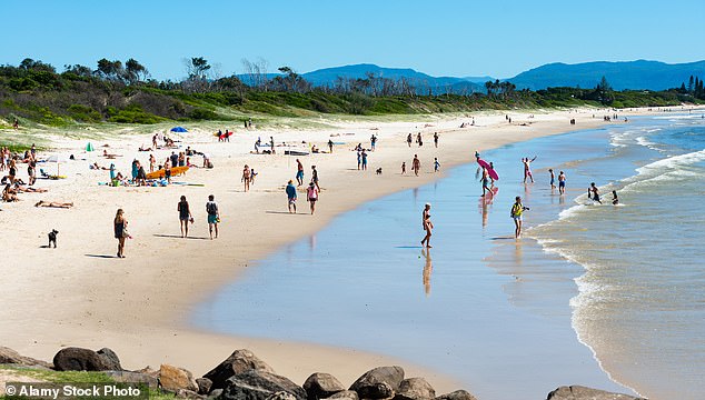 Swimmers can now 'check before they swim' at NSW 's beaches and inland swimming spots, with the state's new real-time water quality monitoring system now up and running (pictured is Belongil Beach in Byron Bay)