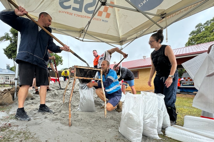 People filling up sandbags.