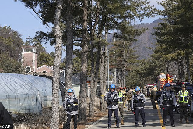 South Korean army soldiers and police officers stand guard near a bomb accident site in Pocheon