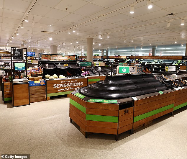 Woolworths will shut its stores in Brisbane, the Sunshine Coast and the Gold Coast from 3pm Friday (pictured: a Gold Coast Woolworths cleared out of fruit on Wednesday)