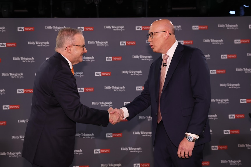 Anthony Albanese and Peter Dutton shake hands at an election leaders' debate
