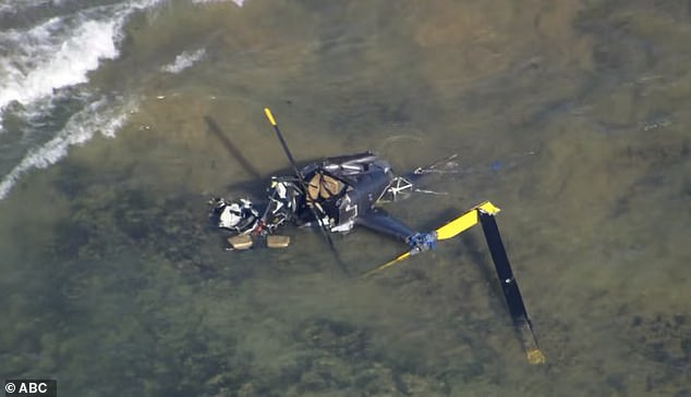 Wreckage from the helicopter is seen in aerial footage of the crash site on Friday