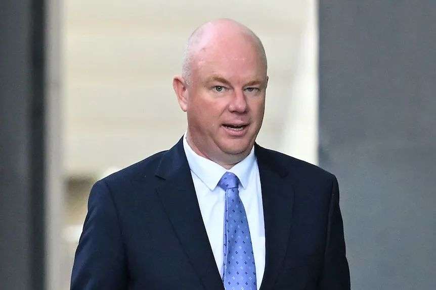Simon Patterson outside court, dressed in a black suit and blue tie.