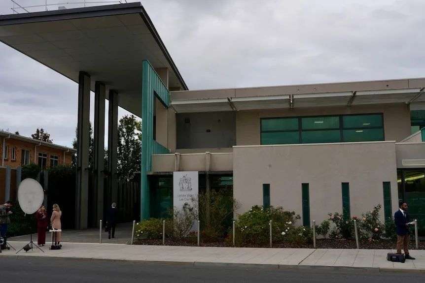 Media stand outside the Latrobe Valley court house in Morwell doing television crosses.