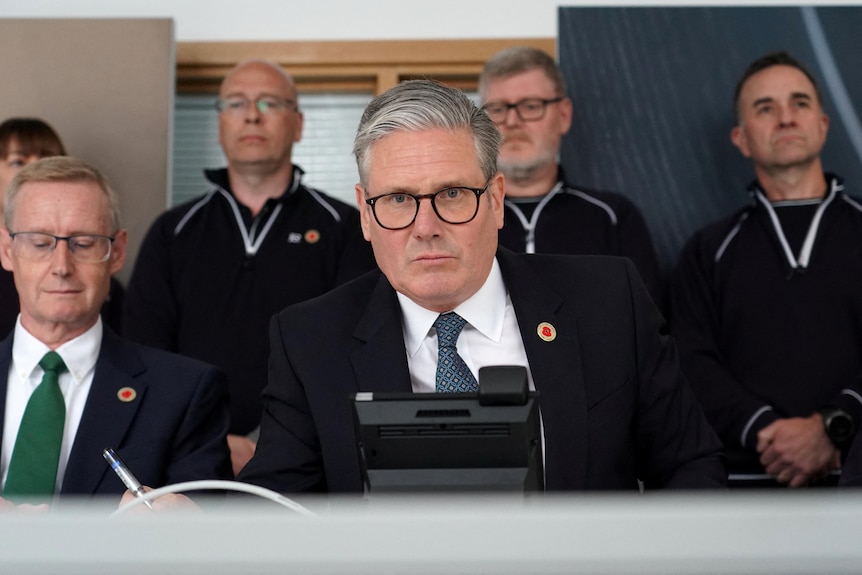 Keir Starmer speaks into a phone in an office