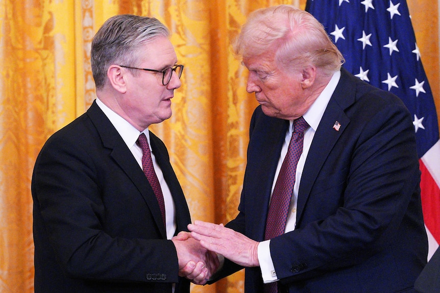 Keir Starmer and Donald Trump shake hands and make eye contact 