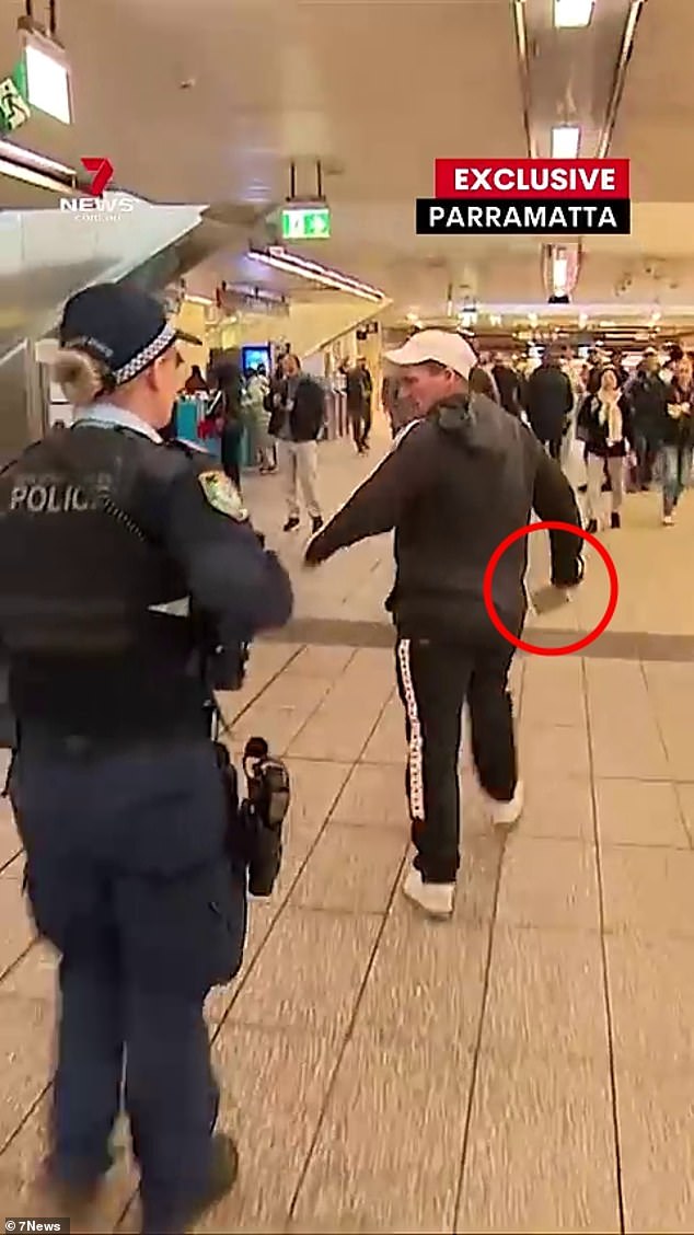 A man wielding a meat cleaver in front of stunned commuters was crash-tackled by police