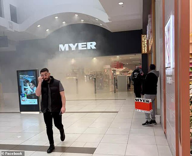 A 'cursed' shopping centre in Melbourne was evacuated on Thursday after a fire broke out less than 24 hours after a vehicle smashed into the building (pictured, smoke coming from Myer)