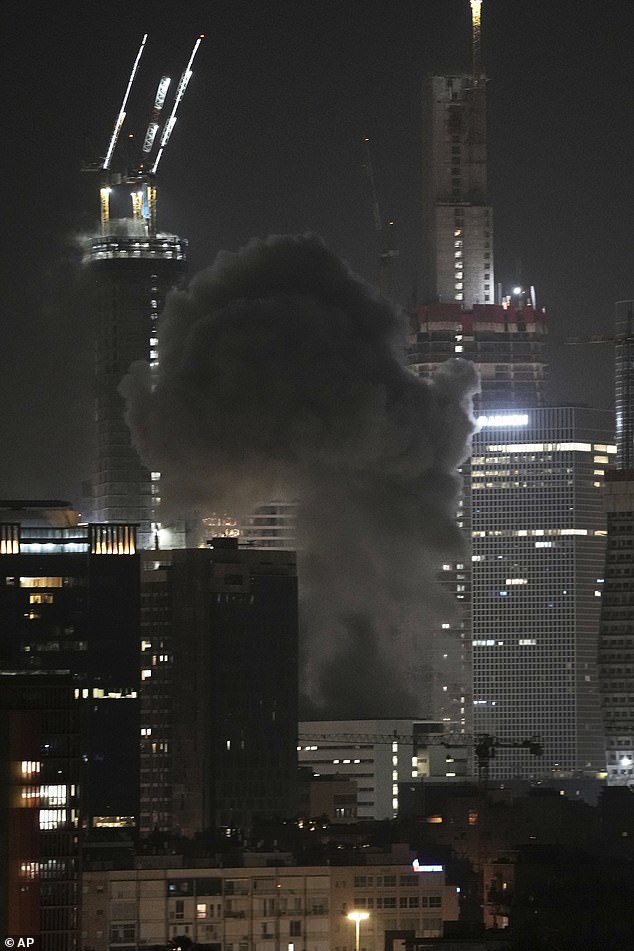 Smoke rises into the air after a projectile hit a building in Tel Aviv, Israel