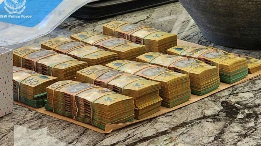 Stacks of cash seized by officers. Picture: NSW Police
