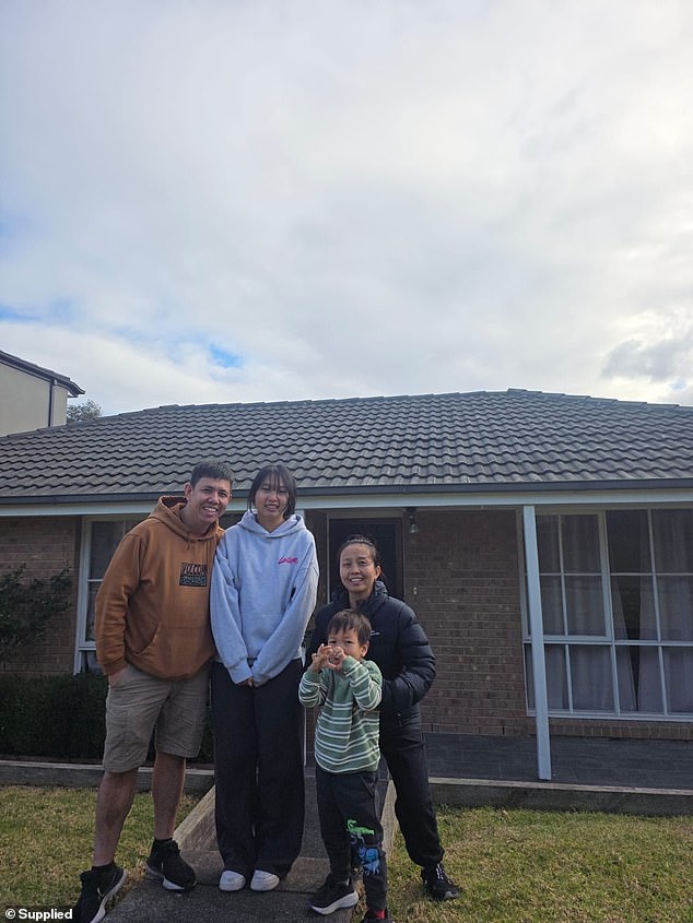 Corey Le pictured with his wife Anna and their two children outside their first home in Packenham, in regional Victoria