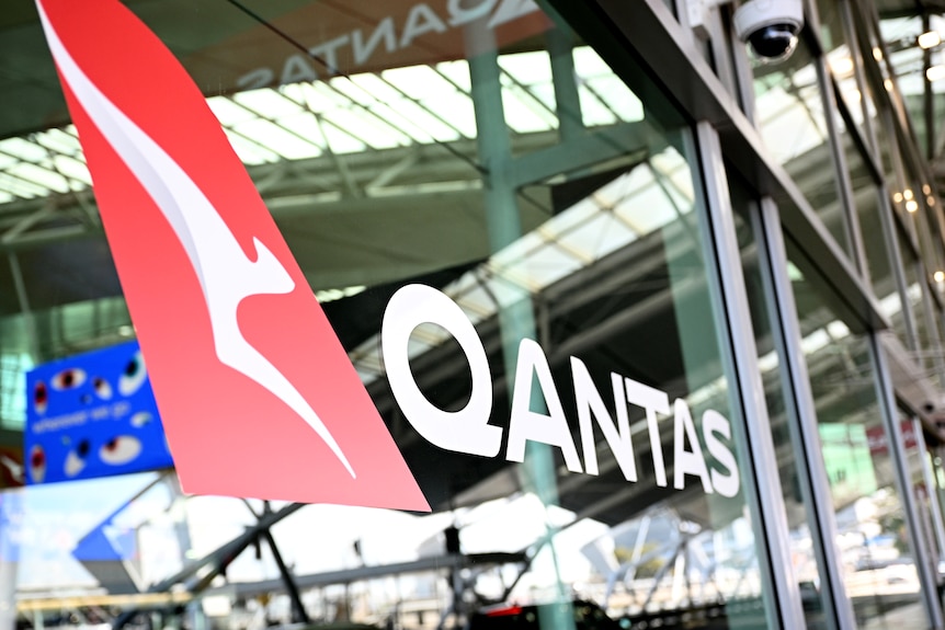 Qantas logo on Sydney Airport terminal glass