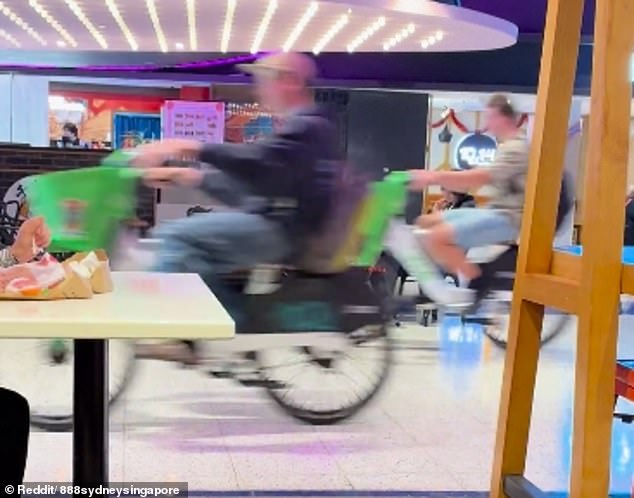 The group of young men ride through George Street Event Cinemas in Sydney