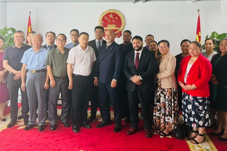 men and women stand in a line.