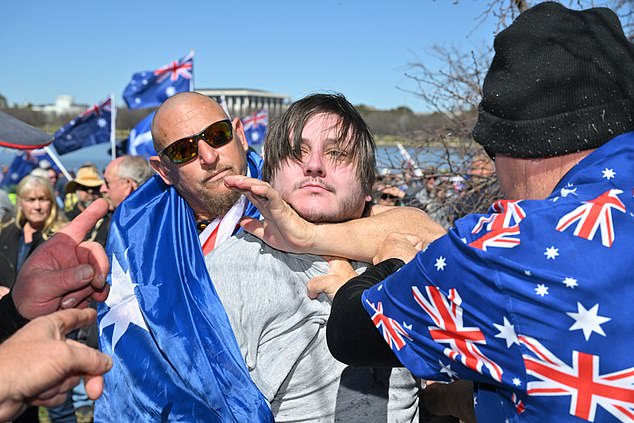 2025 年 8 月 31 日星期日,在堪培拉举行的澳大利亚反移民游行集会上,一名反法西斯抗议者被反移民抗议者制服。(AAP 图片/Mick Tsikas)无存档