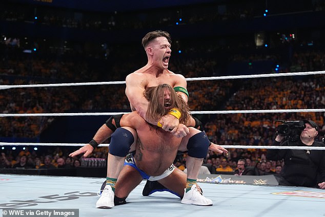 The booing took place just before stars like John Cena (pictured, top) wowed the crowd on Saturday night, local time