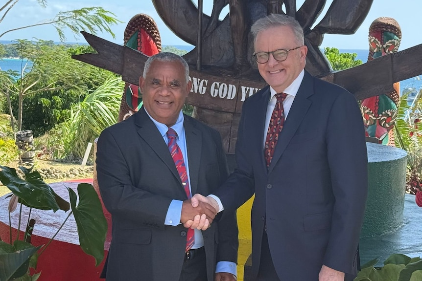 Vanuatu's Prime Minister Jotham Napat and Anthony Albanese shake hands.