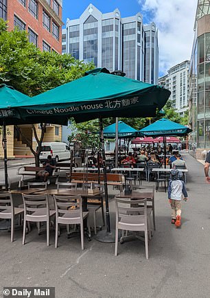 Diners have the option to sit inside the small eatery or at outside tables under green umbrellas