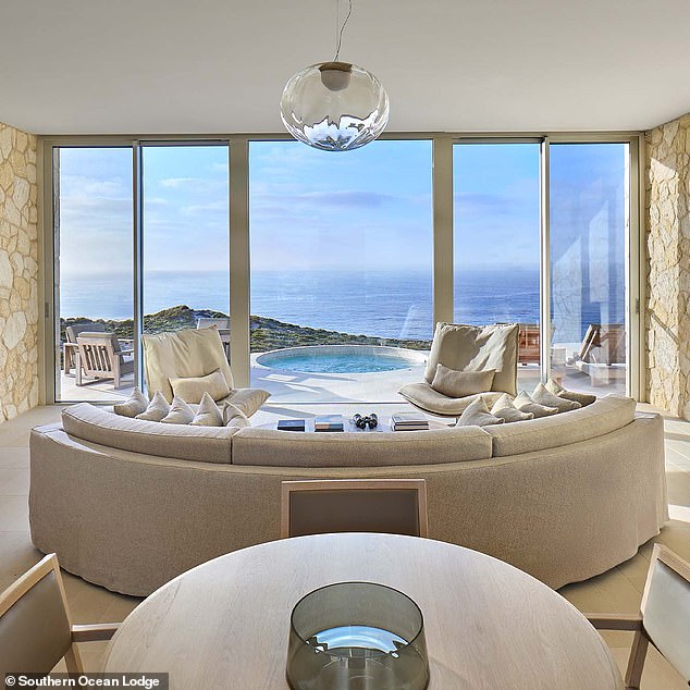 Pictured is a living room complete with a massive couch and a view of the jacuzzi