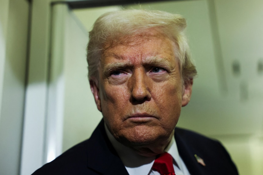 Donald Trump looks on aboard Air Force One