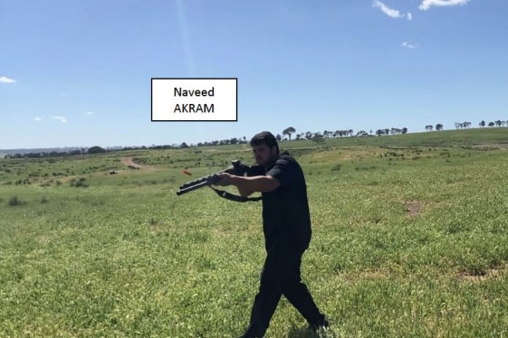 Man holds a rifle in a green field. White text box says Naveed Akram 