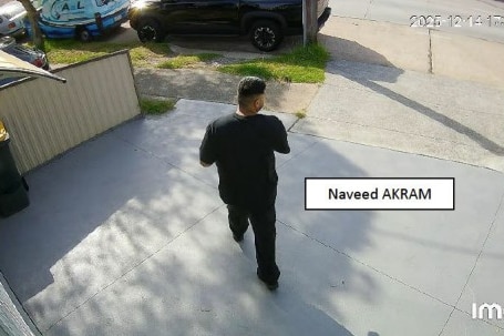 Man in dark clothing walks down driveway. Text box says Naveed Akram.