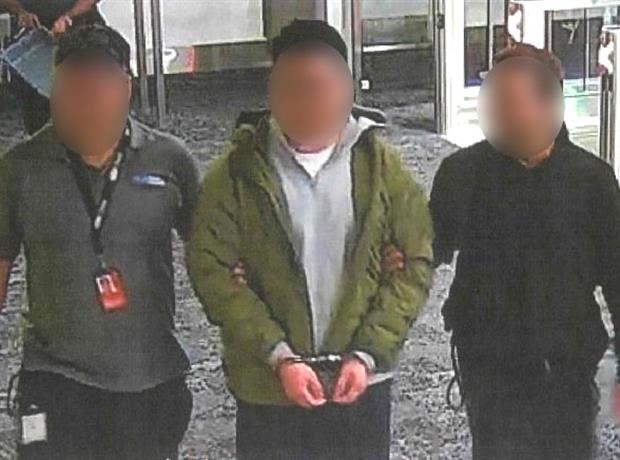 Image for Traveller being escorted