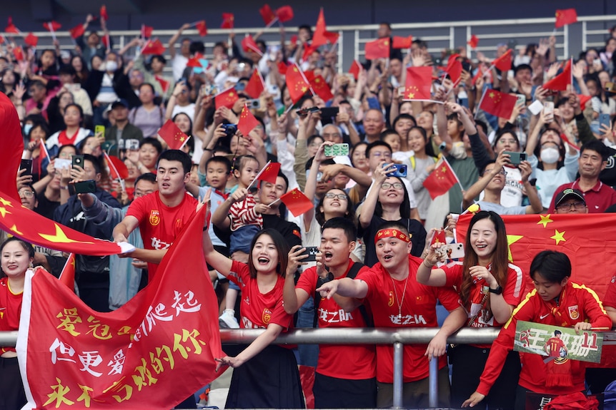 China fans celebrate in the stands after the match.