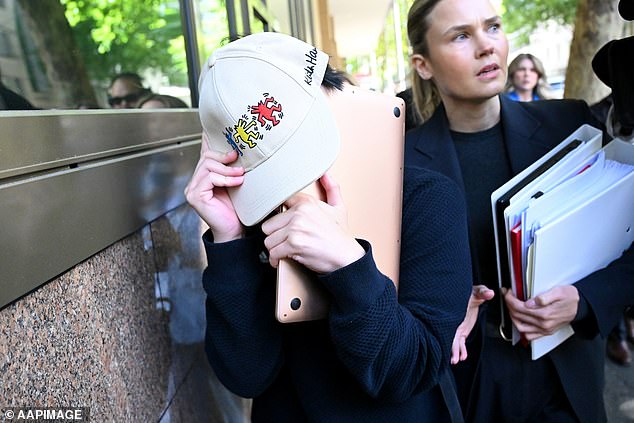 Bao Phuc Cao (left) tried desperately to conceal his face as he left the Magistrates Court of Victoria in Melbourne last Friday