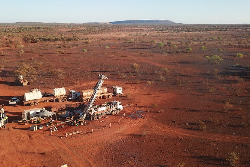 An aerial photo of a desert patch with mining equipment