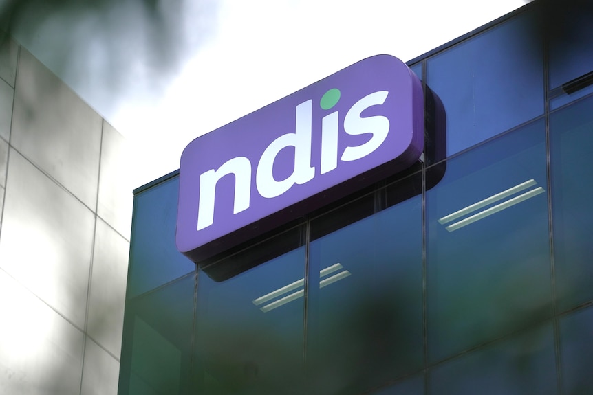 An NDIS logo is seen on a building