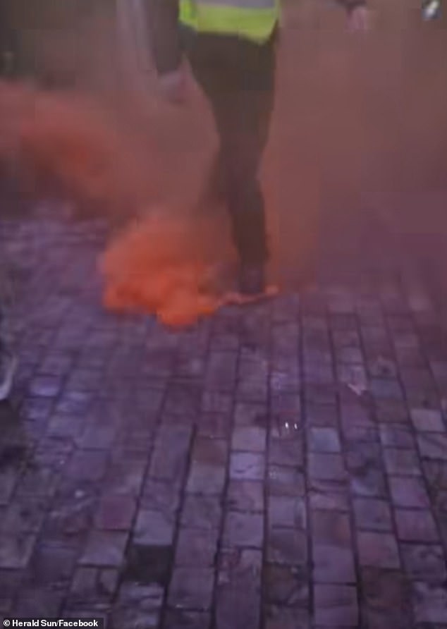Stewards rushed to stamp out flares that had been left burning on the ground inside the crowded Melbourne fan zone