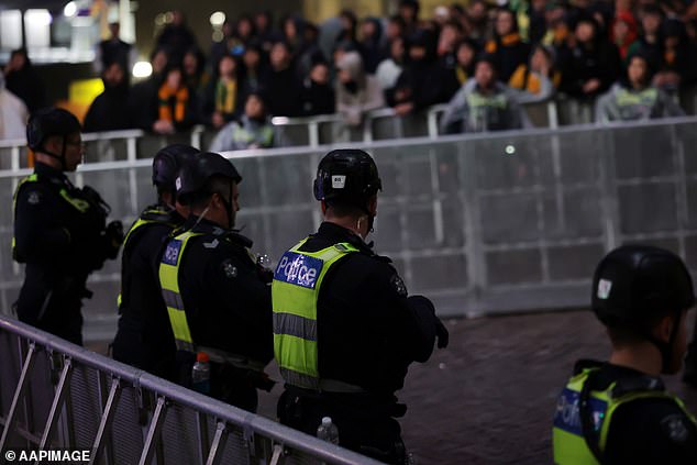 A police officer suffered a minor foot injury after being crushed against a barrier during the crowd surge
